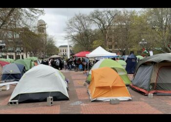 Israel supporter stands near pro-Palestinian encampment on campus of University of Michigan
