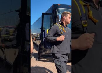 Michigan football players arrive by bus for Michigan vs. USC
